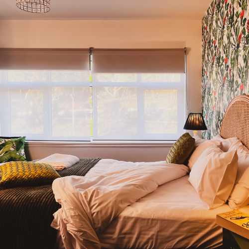 Avitium apartment main bedroom with ruffled bed and cushions